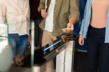 Passengers using smartphone nfc to access public transport turnstile