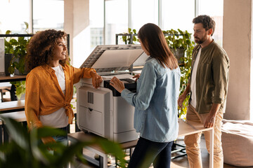 Business team troubleshooting modern office printer issues