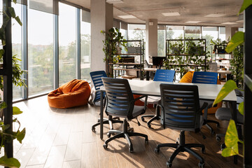 Modern coworking space with comfortable chairs and plants