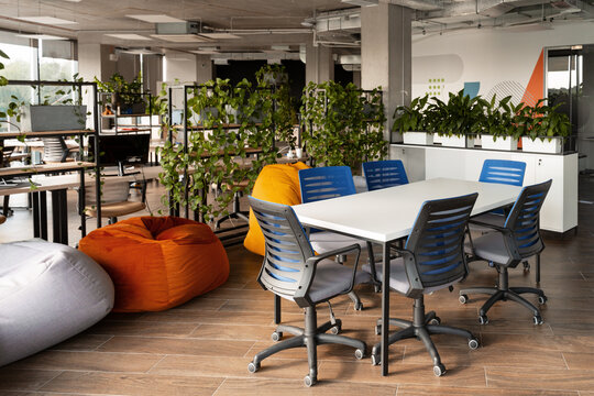 Modern coworking space with plants and beanbag chairs promoting wellbeing