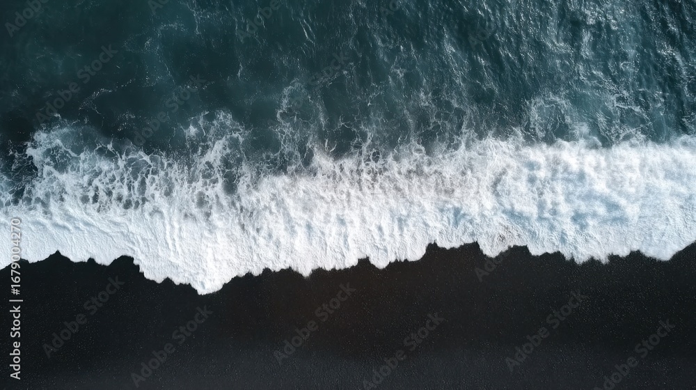 Poster aerial view of ocean waves crashing on dark sandy shoreline creating foamy patterns and texture in n