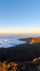 Mountaintop view of clouds and valleys at sunset