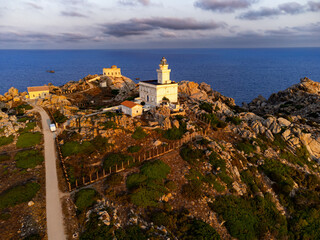 Naklejka premium Aerial view of the Capo Testa lighthouse at dawn