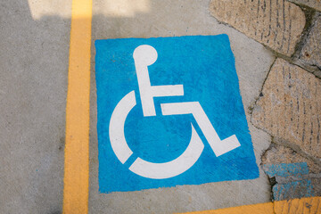 International symbol of access painted on parking spot indicating accessibility