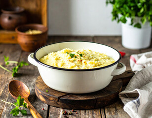 A rustic kitchen scene with a pot of simmering rice porridge