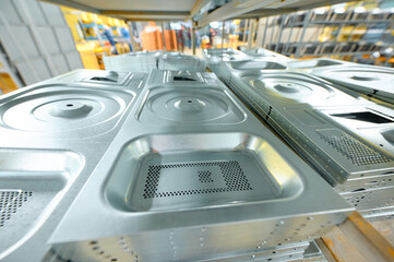 Cold metal stamping parts arranged on shelves in a manufacturing facility for efficient processing and storage