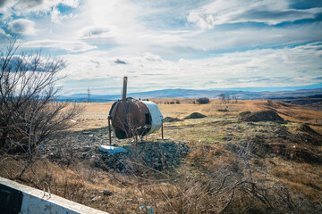 Rusty Oil Tank in a middle of a deserted landscape
