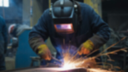 blurry image of someone welding iron, there are sparks, the person is wearing safety clothing, blurry wallpaper