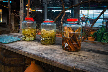 close up of 3 glass jars made of herbs and other ingredients kept outside a hotel as a welcome drink in Sighnaghi, Georgia