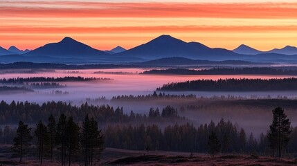 Obraz premium Serene Dawn Over Misty Valley with Majestic Mountains and Colorful Sky at Sunrise