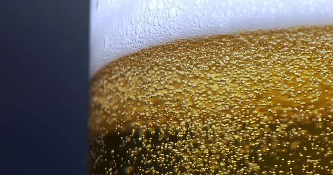 Slow Motion Macro Of Golden Bubbles Rising In Cold Beer Glass With Foam, Abstract Carbonated Liquid Background Texture For Refreshment, Celebration, Beverage And Creative Concept At 1000 Fp