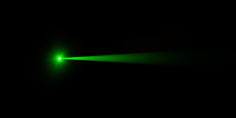 A vibrant green laser beam cutting through darkness.
