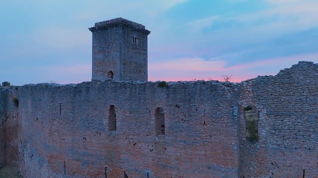 Aerial view from a drone of the sunset at the castle in the town of Ucero, in the Burgo de Osma region, Soria Province, Autonomous Community of Castile and Leon, Spain. Europe