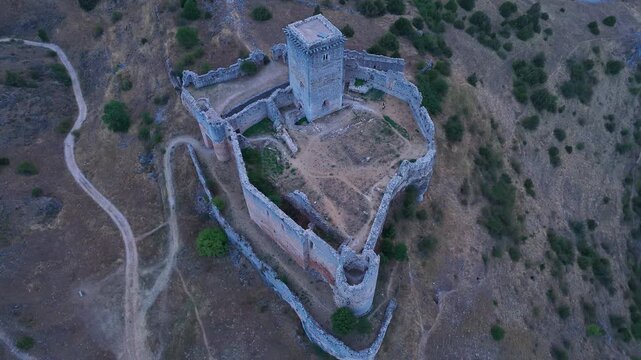 Aerial view from a drone of the sunset at the castle in the town of Ucero, in the Burgo de Osma region, Soria Province, Autonomous Community of Castile and Leon, Spain. Europe