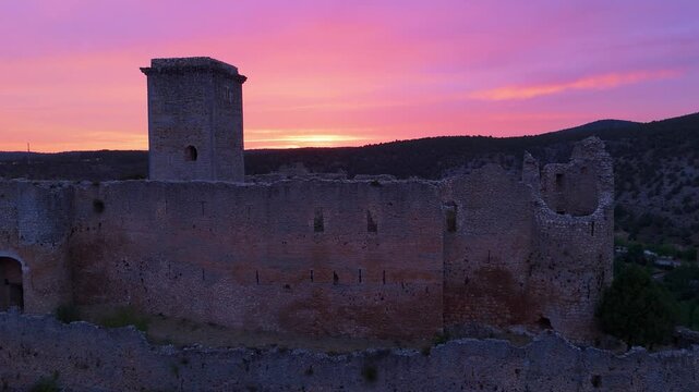 Aerial view from a drone of the sunset at the castle in the town of Ucero, in the Burgo de Osma region, Soria Province, Autonomous Community of Castile and Leon, Spain. Europe