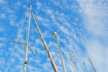Fototapeta premium Wind indicator mounted on sailboat mast against sky. Sailing equipment showing wind direction and speed. Essential gear for navigation, regatta, and cruising