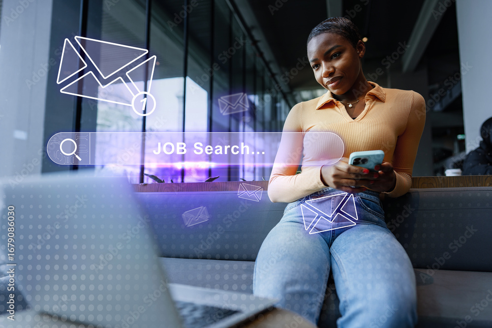 Poster engaging in a job search while sitting in a modern workspace and checking for updates on a mobile de