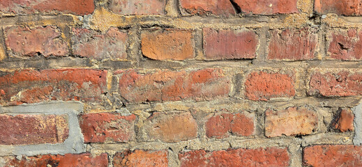 Old red brick wall texture – weathered and brittle surface in high resolution for backgrounds and...