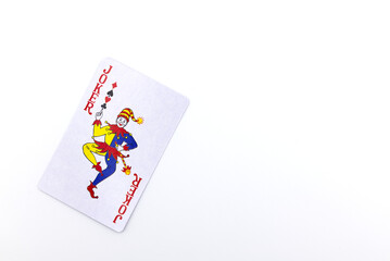 Joker playing card flat lay, isolated on white background.