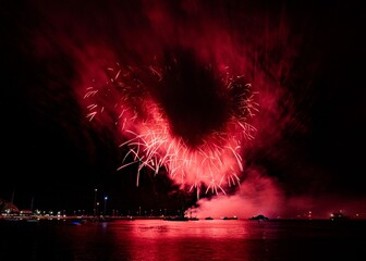 Red Fireworks Over Waterfront