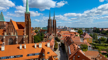 Ostrów Tumski in Wrocław, aerial view of St. John the Baptist Cathedral with red rooftops, Oder River in background, Lower Silesia, Poland, city panorama.