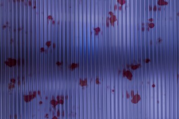 Abstract, vertical lines of translucent material, dotted with small, red shapes;  a diffused,...