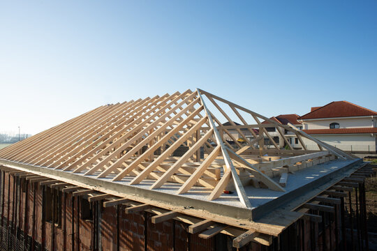 wooden rooftop of a house on a sunny day with clear blue sky