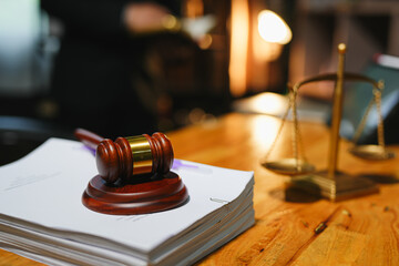 judge on wooden table And experienced lawyers meet with clients and give advice behind the scenes. legal services legal consulting concept
