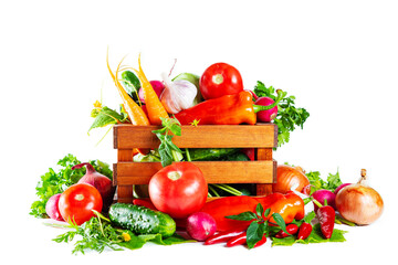 Fresh shiny different vegetables in a wooden crate. Isolated on white background.