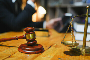 judge on wooden table And experienced lawyers meet with clients and give advice behind the scenes....
