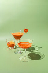 Fresh carrot juice on green background