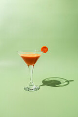 Fresh carrot juice on green background