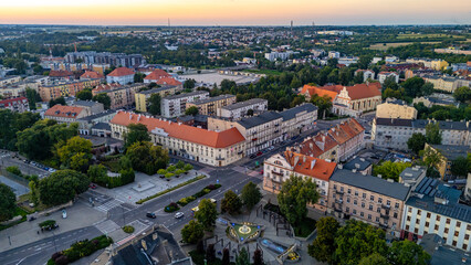 Sunset aerial panorama of Kalisz, view of “Nights and Days” fountain square, historic townhouses, streets and landmark buildings in the city center.