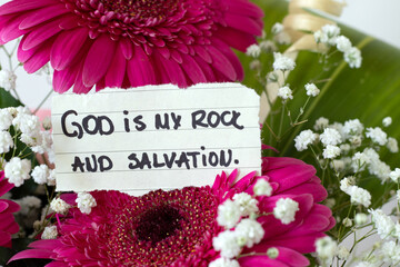 God is my rock and salvation, inspirational Christian quote with flowers. Biblical concept.