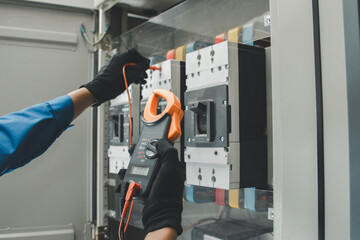 Electrical equipment maintenance service engineer Engineers carry AC voltmeters to check voltage at...