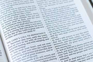 Obraz premium Lord's call to repentance text in open holy bible book. Christian biblical concept of God's mercy, grace and restoration.