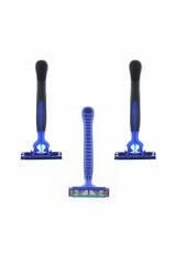 three disposable razors artfully arranged in a symmetrical triangular formation, blue and black handle equipped with a textured, hygiene kits, or shaving equipment,  isolated on white background