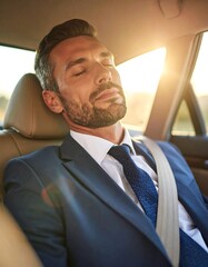 Businessman sleeping in a car
