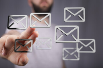 A man interacts with holographic email icons, representing digital communication and email...