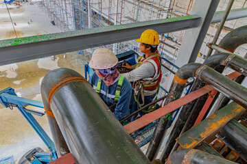 Male workers use high-pressure  tube boilers in industrial areas, chemical products