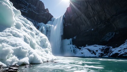 Majestic winter waterfall cascades down rocky cliffs, partially frozen, sunlight gleaming.