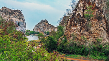 Beautiful nature scenic landscape with mountain range and beautiful hidden spot in Khao Ngu Stone Park at Ratchaburi, Thailand. Landscape view of mountain cliffs In green canyon lake. Amazing nature.