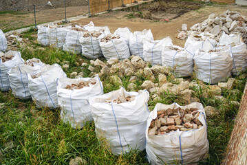 Excavation of Belgrade Fortress, Serbia: extracted old stone blocks and bricks in bulk bags....
