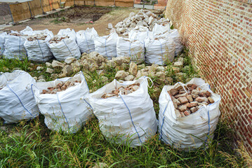 Belgrade Fortress restoration scene: sorted masonry fragments packed in reusable bulk bags....