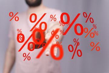 Image depicting a man interacting with floating percentage symbols, ideal for illustrating...