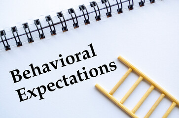 A professional notebook with ladder showing behavioral expectations concept