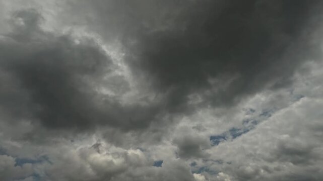 Dramatic timelapse of black clouds moving fast across the sky. Climate and weather concept. Climate change theme. 4K footage