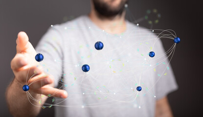 Stock photo of a man interacting with a digital network, showing connections and data flow.