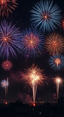 Vibrant Fireworks Display Exploding in Dark Night Sky Above City Silhouette