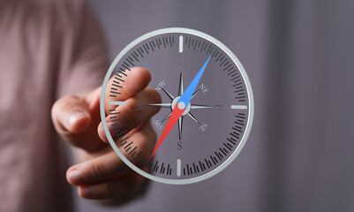 Person interacts with a virtual compass, illustrating navigation, direction, or guidance.